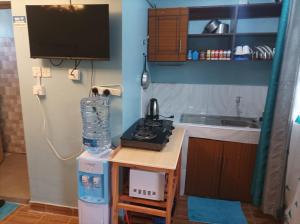 a small kitchen with a small table with a microwave at La Casa Studio in Naivasha