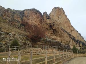 a mountain with a wooden fence next to a road at Casa Rural Tia Catalina in Fuentealbilla