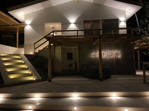 a house with stairs and lights in front of it at Villa Patrizia Pietrasanta in Pietrasanta