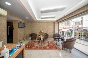un vestíbulo con sillas y una mesa con flores. en Vizyon Hotel, en Estambul