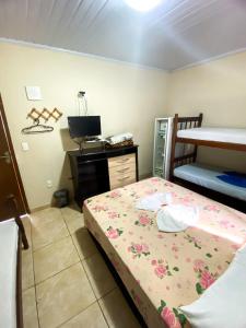 a bedroom with a bed and a bunk bed at Pousada Village Rio Centro in Rio de Janeiro
