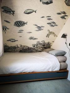 a bedroom with a wall with fish on it at Lanterfant in Nes