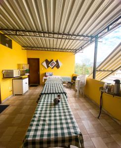 a kitchen with a long table in the middle of a room at Pousada Village Rio Centro in Rio de Janeiro