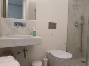 a bathroom with a sink and a toilet and a shower at Graça Modern in Lisbon