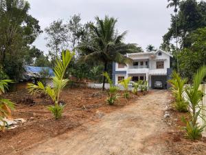 a house with a dirt road in front of it at HOLLYWOOD Villa in Sultan Bathery