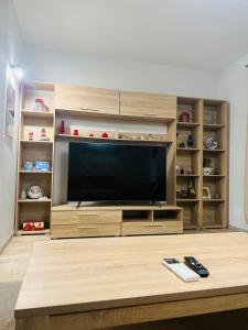 a large entertainment center with a large television in a living room at TOP PROPERTIES AND HOME in Voluntari
