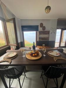 a dining room table with two plates and wine glasses at Shark SeaView Villa in Şarköy