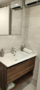 een badkamer met een wastafel en een spiegel bij Apartamento Mc Lion in Alcobendas