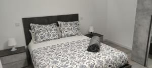 een bed met een zwart-wit dekbed en kussens bij Apartamento Mc Lion in Alcobendas
