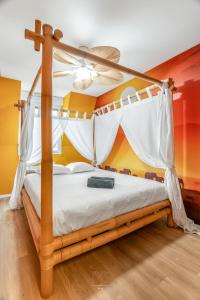 a bedroom with a canopy bed with white curtains at Disneyland-Dream 8 pers,2 parking, Wifi, Netflix in Serris