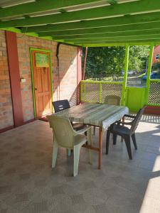 una mesa de madera y sillas en un patio en Seawind Cottage Authentic St.Lucian Accommodation near Plantation Beach en Gros Islet