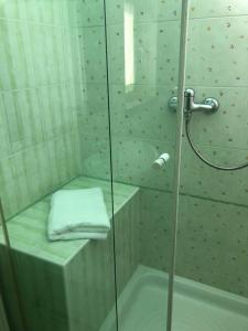 a bathroom with a shower with a glass door at La scala del libro in Santo Stefano di Rogliano