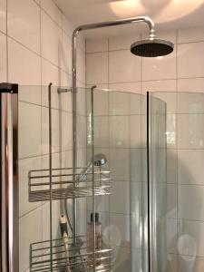 a bathroom with a shower with a glass shower at Annehill i Bro in Bro
