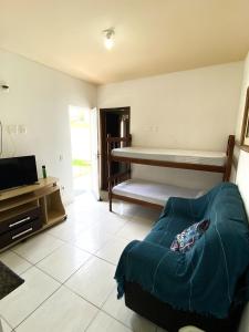 a living room with a couch and a television at Pousada Village Rio Centro in Rio de Janeiro