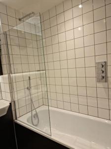 een douche met een glazen deur in de badkamer bij Modern-New Build Apartment in Birmingham in Birmingham