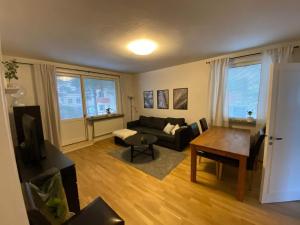 a living room with a couch and a table at Stockholm Apartment Hammarbyhöjden in Stockholm