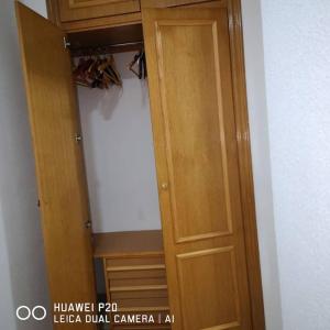 a closet with a wooden door in a room at Apartaestudio arrixaca 2 el Palmar Tv Wifi Aire in El Palmar