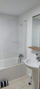 a white bathroom with a sink and a shower at Apartaestudio arrixaca 2 el Palmar Tv Wifi Aire in El Palmar