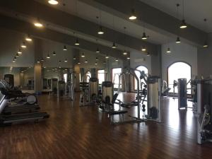a gym with treadmills and exercise equipment in a room at فلل نادي الصيد in 6th Of October