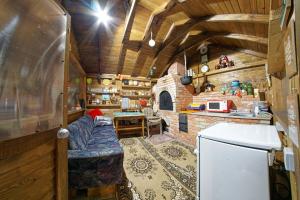 a living room with a couch and a kitchen with a refrigerator at Casa Mia in Câmpulung Moldovenesc