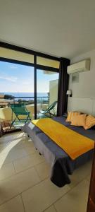 a bedroom with a large bed with a view of the ocean at CosySeaside Corsica Ajaccio Piscine Terrasse Mer in Ajaccio