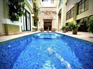 a swimming pool in the middle of a building at AmazINN Places Casco Viejo relaxing Views and Sound of the Sea in Panama City