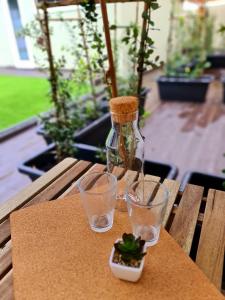 a table with three glasses and a bottle on it at VILLAS com piscina in Vila Nova de Gaia