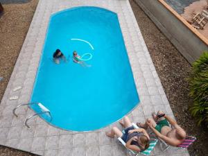 a group of people laying in a swimming pool at Hospedagem Tia Nena in Pomerode