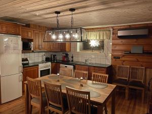 a kitchen with a table and chairs and a refrigerator at Åre Hårbörsta 2:64 in Åre