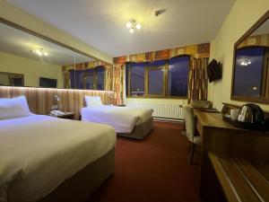 Letto o letti in una camera di West County Hotel