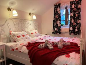 a bedroom with a bed with two leopard slippers on it at Kuća za odmor Čarolija in Jastrebarsko