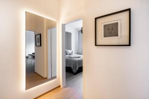 a hallway with a mirror and a bed in a room at Apartment 1919 in Kitzbühel