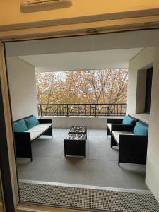 a large living room with couches and a balcony at Appartement Saint ouen proche stade de france in Saint-Ouen