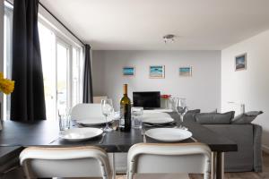 a dining room and living room with a table and chairs at Wheal Rose -Beautifully Fitted Lodge Helston Cornwall in Helston
