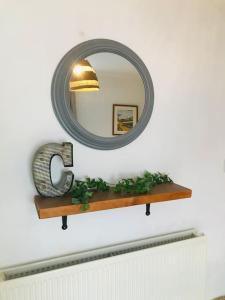 a mirror on top of a shelf on a wall at Spacious 3 bed house near beach! in Lowestoft