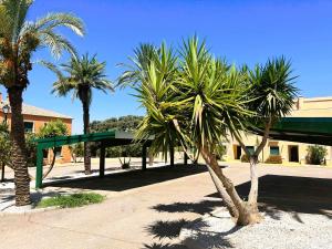 un groupe de palmiers devant un bâtiment dans l'établissement Villas Rurales Arroyovil, à Mancha Real