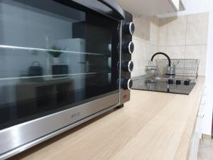 a microwave oven sitting on top of a kitchen counter at Apartament La Vivi in Lupeni +12 photos