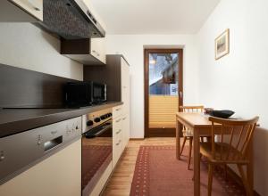 a kitchen with a table and a dining room at Gurglerhof in Sölden