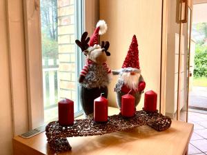 two stuffed animals are standing on a table with candles at Villa Seashell in Lignano Sabbiadoro
