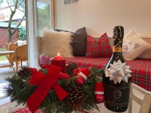 a bottle of wine and a christmas wreath on a couch at Villa Seashell in Lignano Sabbiadoro