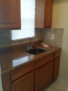 a kitchen counter with a sink and a window at Shores Terrace in Pompano Beach