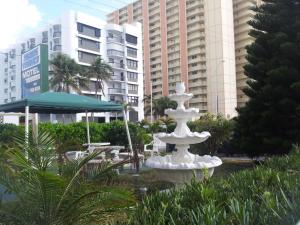 a white fountain in front of some tall buildings at Shores Terrace in Pompano Beach