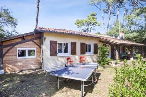 a house with a ping pong table in front of it at Villa de la Côte - Welkeys in Labenne +17 photos