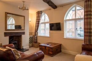 a living room with a fireplace and a mirror at Charming 2 Bed House in Tewkesbury Centre in Tewkesbury
