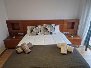 a bedroom with a large bed with two pillows on it at Cabañal Home in Valencia