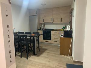 a kitchen with a table and chairs in a room at La Barbería in Cascante del Río