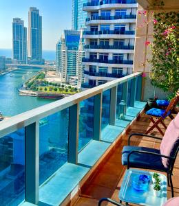 einen Balkon mit Stühlen und Blick auf das Wasser in der Unterkunft Fabolous Vacation Home in Dubai Marina in Dubai