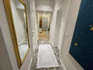 a hallway with a mirror and a bathroom at Herz von Wien Mariahilfer in Vienna