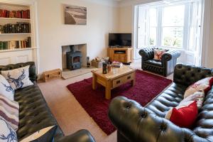 a living room with two couches and a coffee table at Edengrove in Aberfeldy