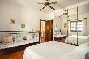 a bedroom with two beds and a ceiling fan at Villa Vistafuerte in Playa Blanca
